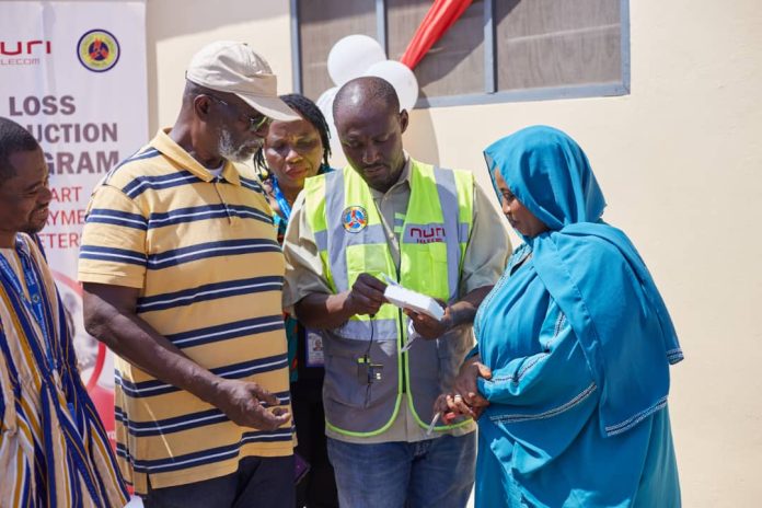 An official of ECG educating some customers on the newly installed meters